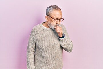 Handsome senior man with beard wearing casual sweater and glasses feeling unwell and coughing as symptom for cold or bronchitis. health care concept.