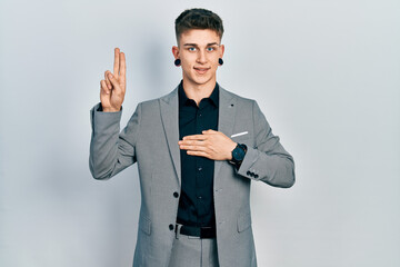 Young caucasian boy with ears dilation wearing business jacket smiling swearing with hand on chest...