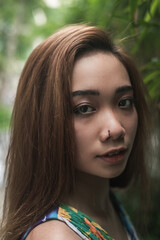 Fototapeta premium Close-up portrait of pretty young asian woman outdoor. Beautiful sunlight. High quality photo 