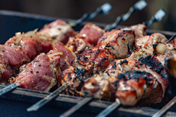 Fresh shish kebab on skewers is fried on the grill.
