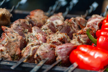 Fresh shish kebab on skewers is fried on the grill.