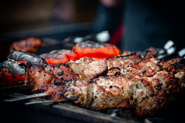 Fresh shish kebab on skewers is fried on the grill.