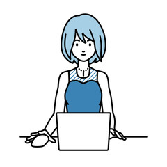 デスクで座ってPCを使っているドレスの女性