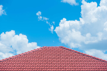 Fototapeta na wymiar red roof with the blue sky background