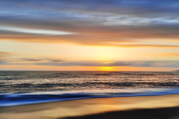 Beautiful sunset over the sea, blurred background for design.