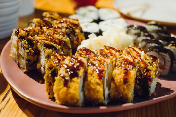 apanese sushi food. Maki ands rolls with tuna, salmon, shrimp, crab and avocado. assorted sushi. Close-up, selective focus.