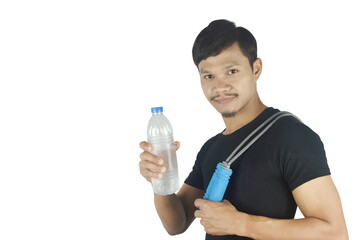 Strong and healthy young man holding a jumping rope at his shoulders with water bottle and looking at camera with smile on white background. copy space.