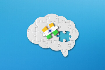 Indian learning concept, white jigsaw puzzle pieces with indian flag a human brain shape on blue...