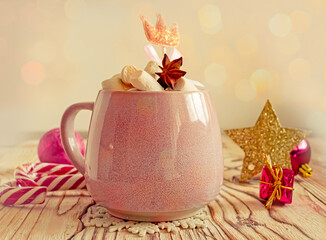 Christmas drink background, pink cup with hot chocolate and marshmallows on a wooden table near New Year's decor. Cocoa Christmas drink, copy space, bokeh effect, drink mug Christmas holiday 