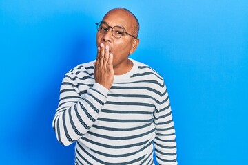 Middle age latin man wearing casual clothes and glasses bored yawning tired covering mouth with hand. restless and sleepiness.