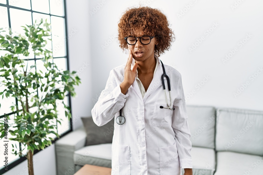 Sticker young african american woman wearing doctor uniform and stethoscope touching mouth with hand with pa