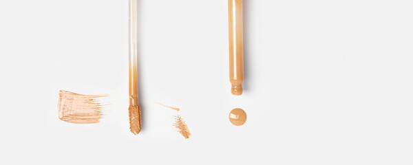 Skin serum foundation brush stroke with brush for applying isolated and liquid serum from with dropper on white background