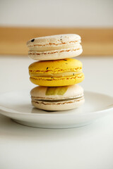 Macaroons on white plate. French cuisine dessert. Gentle colors