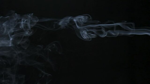 Slow motion. Movement of white smoke. Smoke stream curve, line and swirls. Isolated