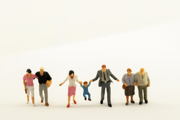 Miniature people Family Father Mother and Children standing on white background with copy space happiness using for travel around the world business trip traveler adviser agency or online world market