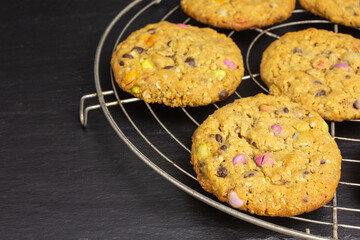 chocolate chip cookies with peanut butter, rolled oats and colorful chocolate candy