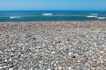 Fototapeta na wymiar grey and white pebble beach on the mediterranean sea