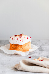 Traditional Easter cake, decorated with sugar decor icing, berries, flowers on grey background. Happy Easter Holidays, copy space.