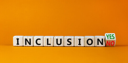 Inclusion yes or no symbol. Turned a wooden cube and changed words 'inclusion no' to 'inclusion yes'. Beautiful orange background. Business and inclusion yes or no concept, copy space.