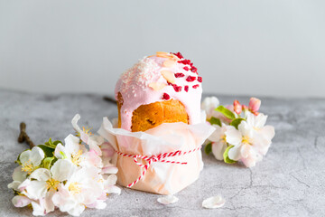Traditional Easter cake, decorated with sugar decor icing, berries, flowers on grey background....
