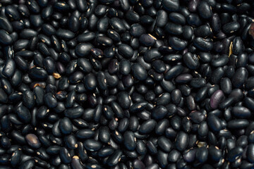 Piled black beans texture background.