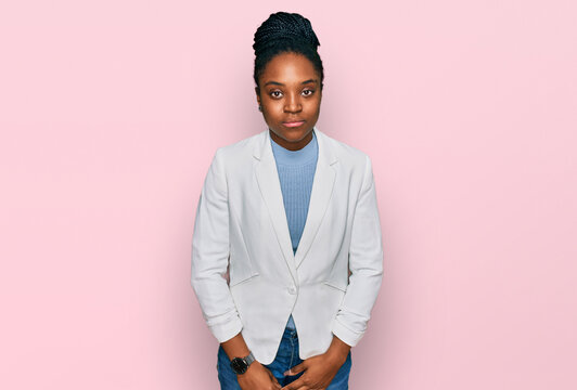Young african american woman wearing business clothes looking sleepy and tired, exhausted for fatigue and hangover, lazy eyes in the morning.