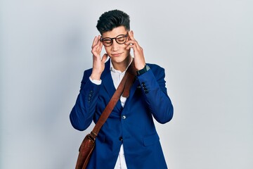 Young hispanic man wearing business clothes with hand on head for pain in head because stress....