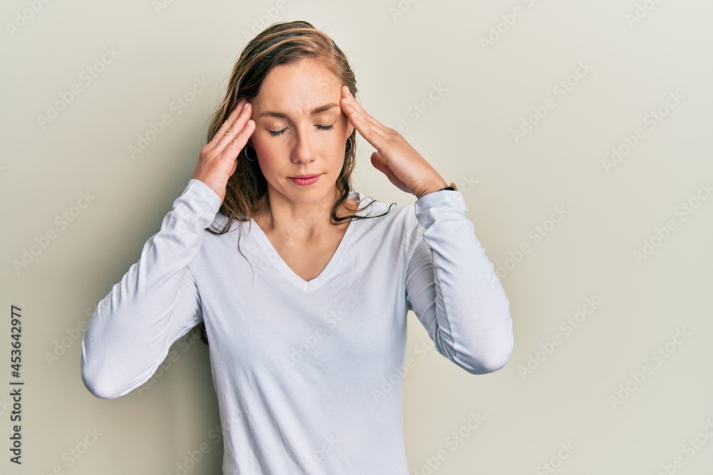 Poster young blonde woman wearing casual clothes with hand on head for pain in head because stress. sufferi