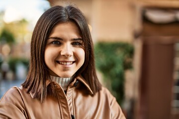 Young beautiful brunette woman smiling happy outdoors