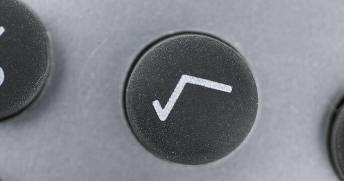 Rotation. Close-up of black button with SQUARE ROOT symbol.
