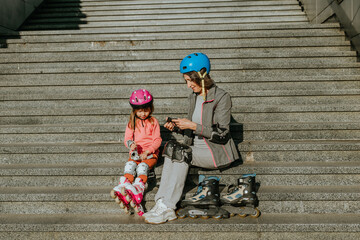 Grandmother and granddaughter are preparing for roller skating