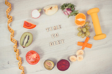 Dumbbell, centimeter and nutritious food as source natural vitamins, healthy nutrition and slimming concept