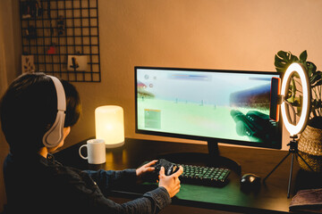 Girl playing battle online video game streaming on twitch - Technology trend concept - Focus on...