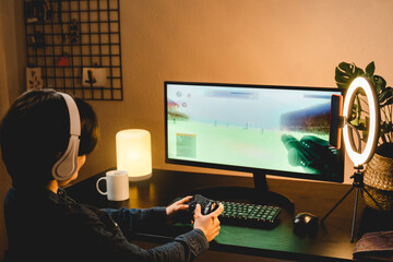 Girl playing battle online video game streaming on twitch - Technology trend concept - Focus on hands holding controller © Vane Nunes