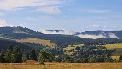 Fototapeta na wymiar A panoramic view to the Plessberg hill and surrounding landscape with morning fog at Ore Mountains, Czech republic
