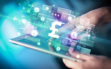 Close-up of a hand using tablet, currency concept