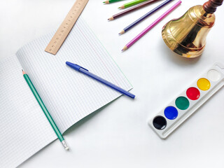 School life. School bell. Stationery on white background