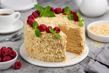 Homemade layered cake Napoleon with custard, decorated with raspberries and mint. Puff pastry. Selective focus. 