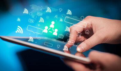 Close-up of a hand using tablet, social media concept