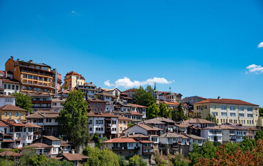 Houses with red tiled roofs , built on a mountain under a bright blue sky.Veliko Tarnovo in a beautiful summer day, Bulgaria