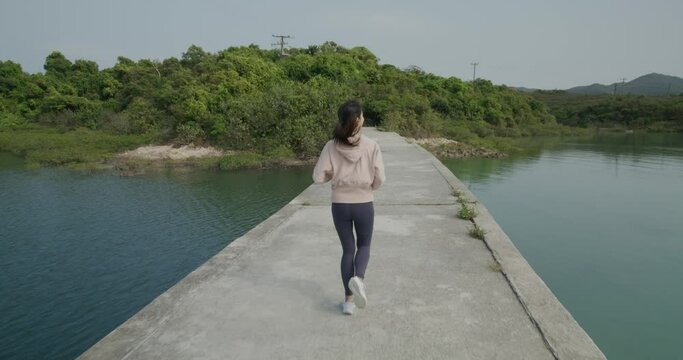 Woman run on the stone bridge