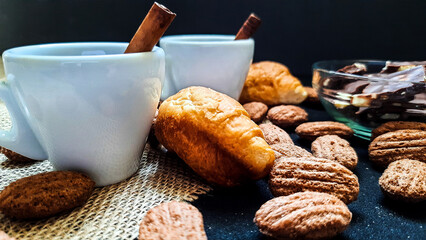 Breakfast. Coffee with cinnamon, croissants and sweets