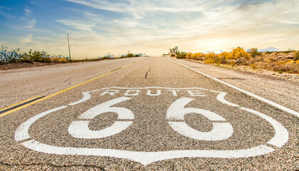 Route 66 road sign with blue sky background. Classic concept for travel and adventure in a vintage way.