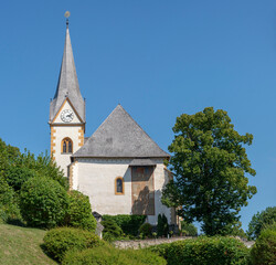 Fototapeta na wymiar The Church of Maria Worth at Lake Worthersee in Carinthia, Austria in Summer.
