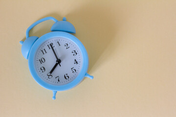 Blue vintage alarm clock on a light background.