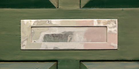 Old letterbox in the door, traditional way of delivering letters to the house, old mailbox