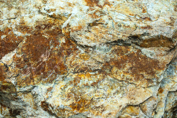 The texture of the stone in natural light. Rock details.