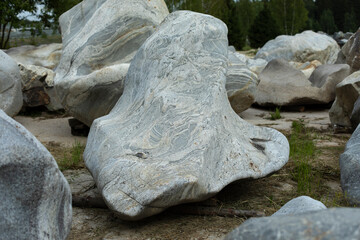 Fototapeta na wymiar A large stone of unusual shape. White cobblestone.
