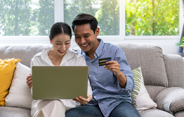 Happy Smiling Couple with Online Shopping Using Credit Card to Internet Shop on-line.