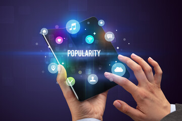 Businessman holding a foldable smartphone